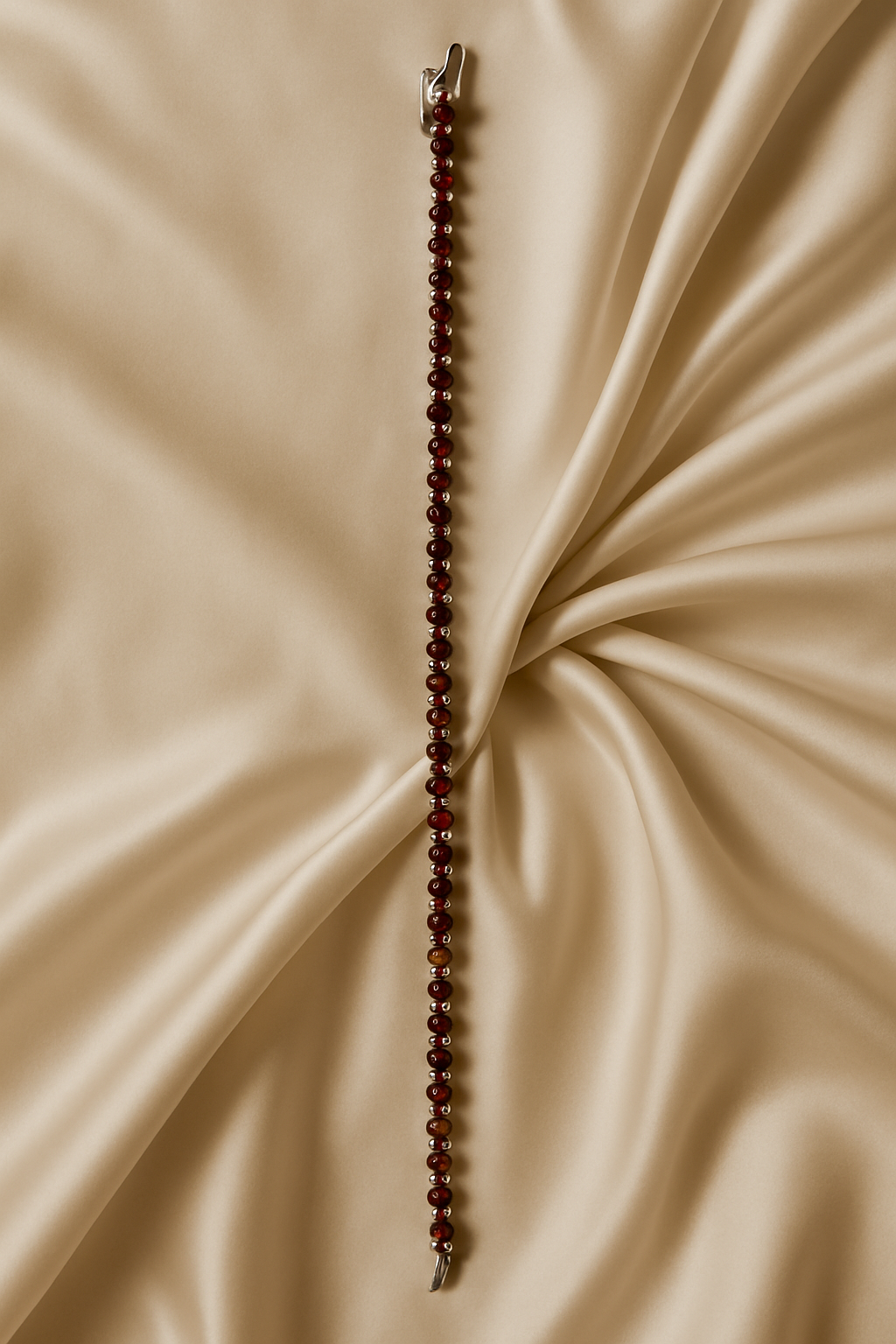 Beaded necklace on a beige fabric background