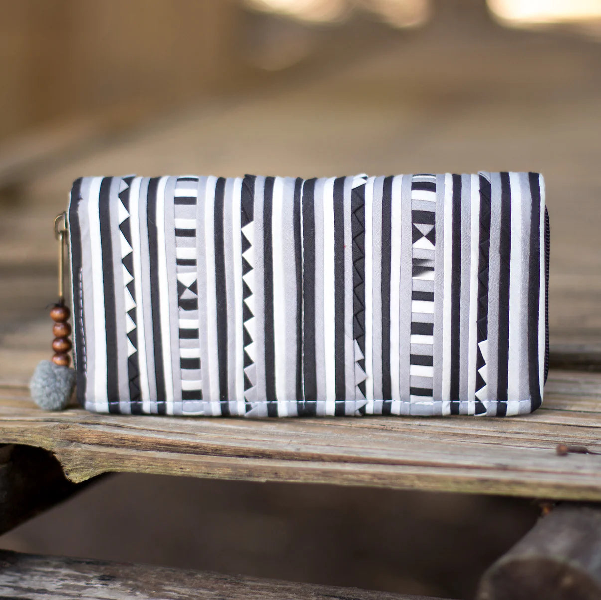 One-of-a-kind Lisu fabric wallet handmade in Northern Thailand, featuring bold geometric tribal patterns and wooden bead zip pull – Suzys Treasures
