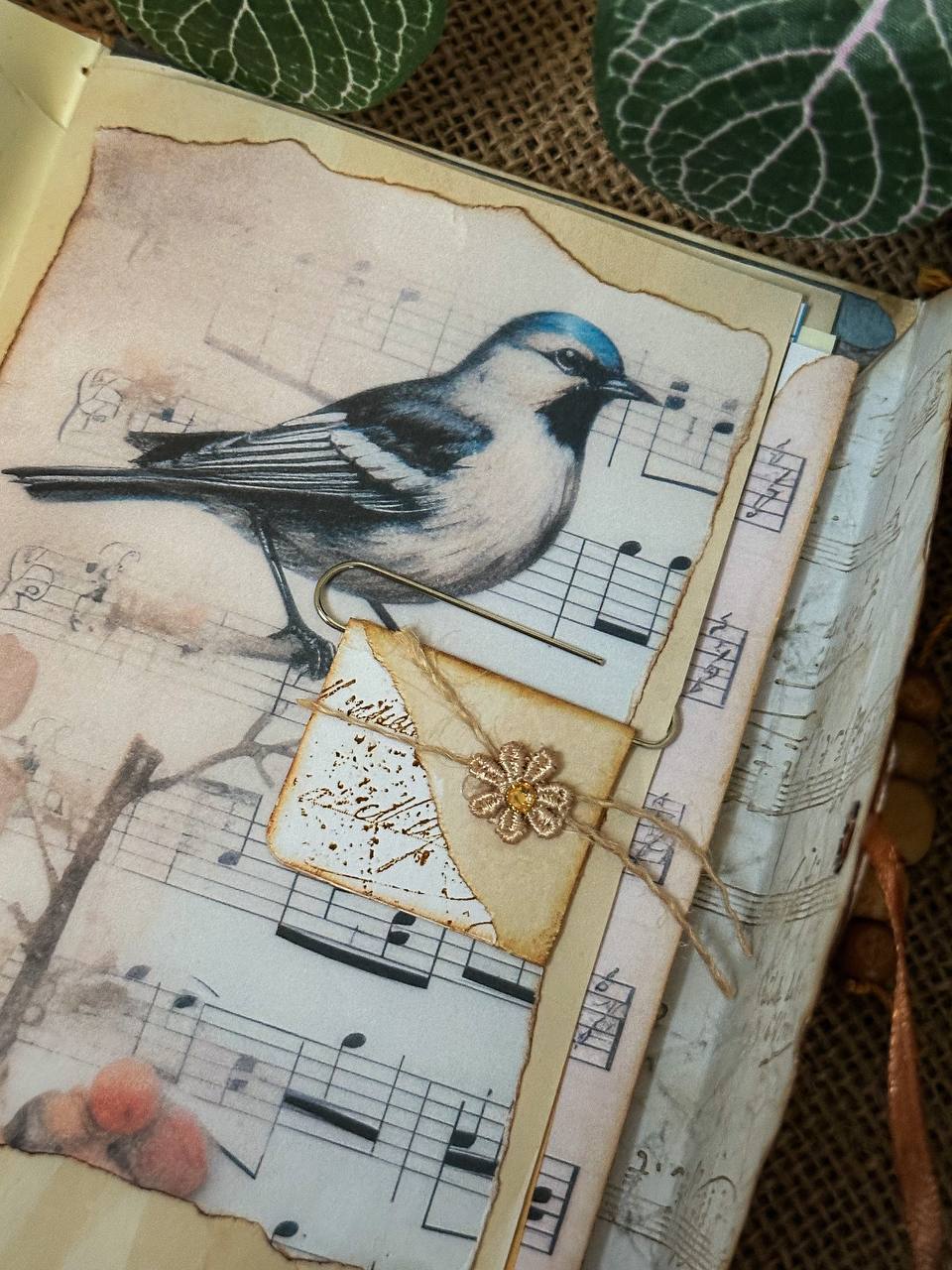 Inside page of Suzys Treasures vintage envelope journal featuring a decorative 'To Do' list insert with floral and leaf illustrations, set on aged paper with green leaf accents and rustic textures.