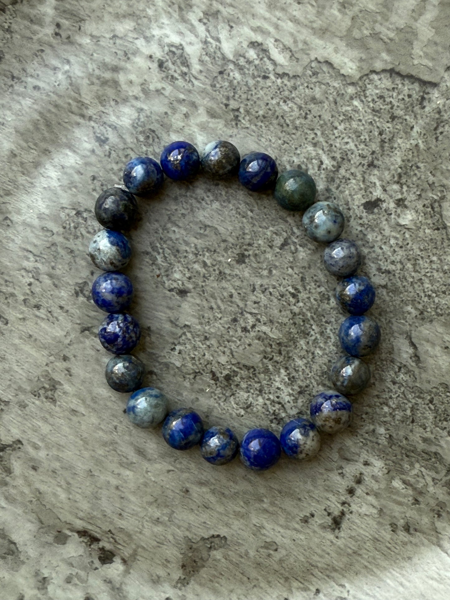Lapis Lazuli round bead bracelet featuring 21–22 deep blue polished stones, known for enhancing wisdom and inner truth – from Suzys Treasures.