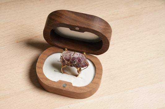 Raw Strawberry Quartz crystal ring wrapped in gold-plated wire, displayed in a wooden ring box – Suzys Treasures handcrafted healing jewelry.