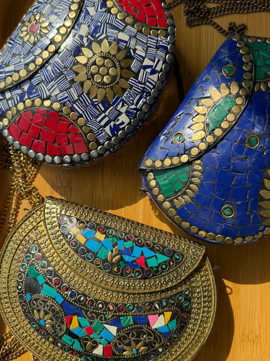 Colorful mosaic bags on a wooden surface