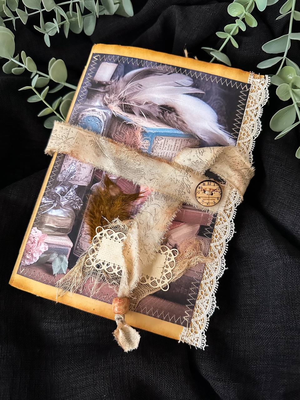 Handmade vintage-inspired journal featuring feathers, apothecary bottles, and lace detailing – a whimsical creation from Suzys Treasures.