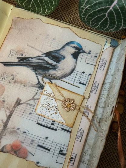 Inside page of Suzys Treasures vintage envelope journal featuring a decorative 'To Do' list insert with floral and leaf illustrations, set on aged paper with green leaf accents and rustic textures.