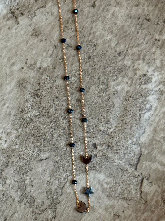 Suzys Treasures handcrafted short necklace with blue-grey hematite beads on a silver embossed, warm-toned 3-micron plated chain, displayed on a textured stone background.