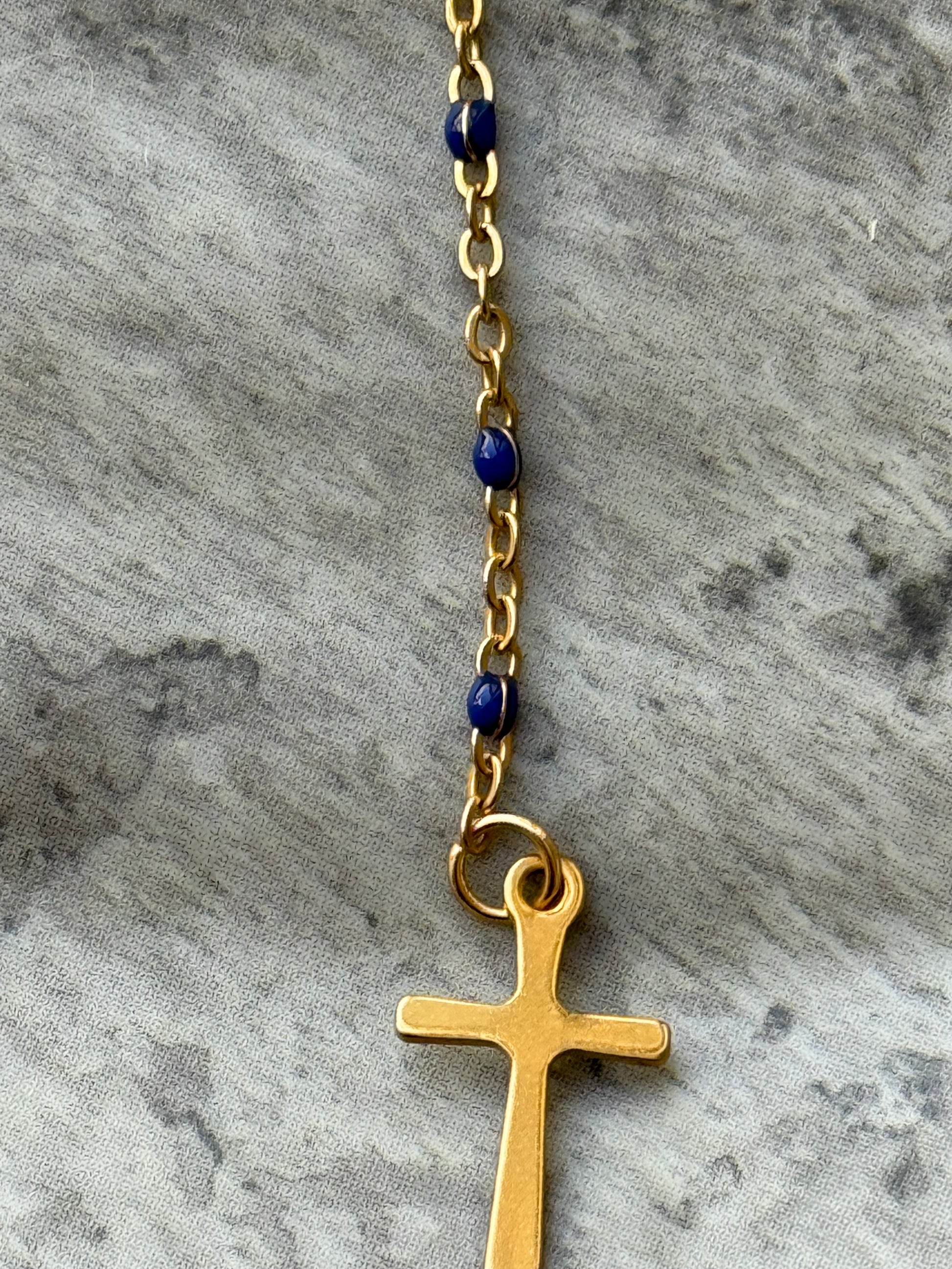 Handcrafted gold cross necklace featuring deep blue lapis lazuli beads and Our Lady of Guadalupe detail from Suzys Treasures.