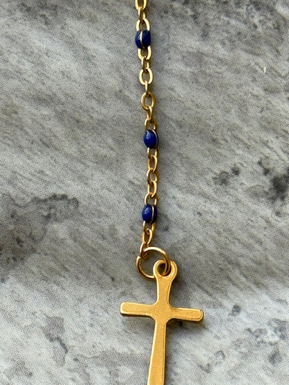Handcrafted gold cross necklace featuring deep blue lapis lazuli beads and Our Lady of Guadalupe detail from Suzys Treasures.