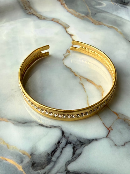 Minimalist copper bangle with single row zirconia crystals and 3-micron gold plating on marble background – Suzys Treasures