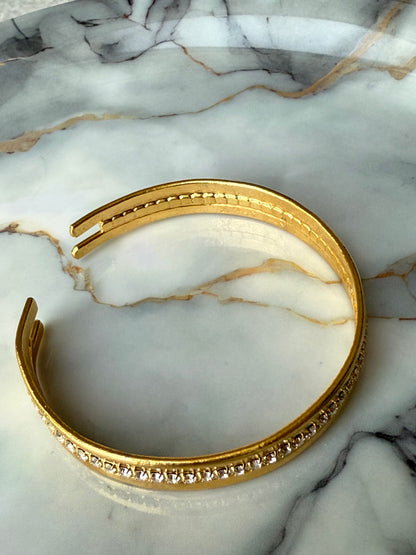 Minimalist copper bangle with single row zirconia crystals and 3-micron gold plating on marble background – Suzys Treasures