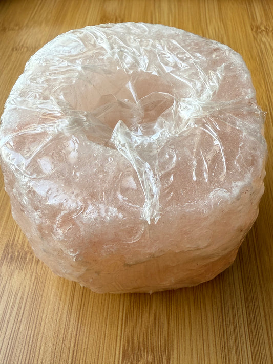 Round Himalayan salt candle holder made from natural pink salt from Pakistan, ideal for purifying energy and creating a peaceful glow, part of the Sacred Scents & Space collection at Suzys Treasures.