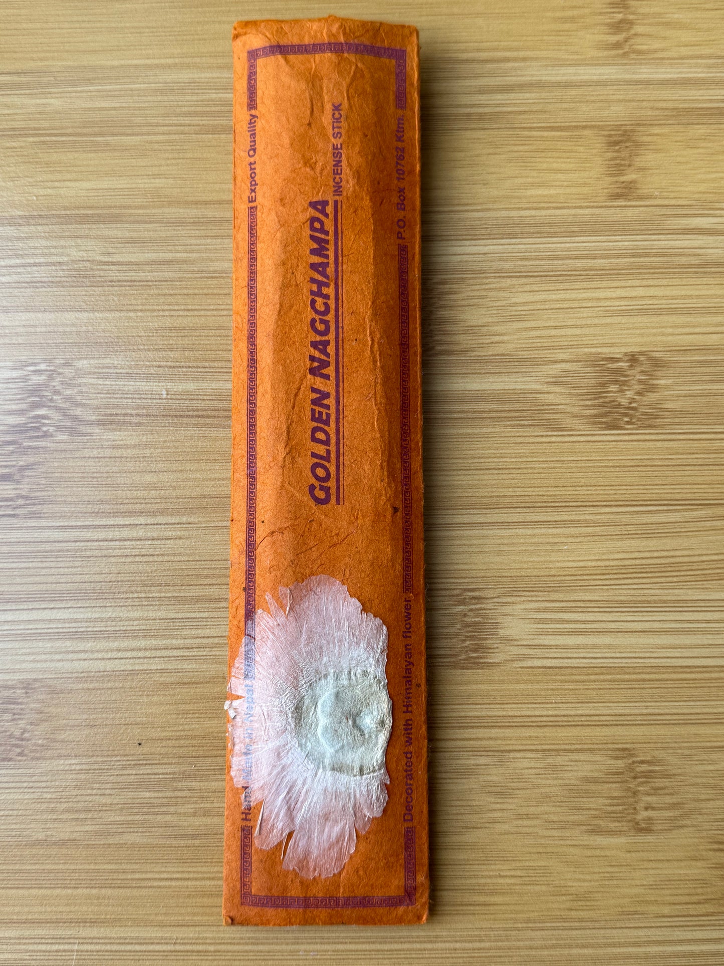 Handmade incense stick pack in Golden Nagchampa, wrapped in eco-friendly lokta paper, 100% natural and made in Nepal, part of the Sacred Scents & Space collection by Suzy’s Treasures.
