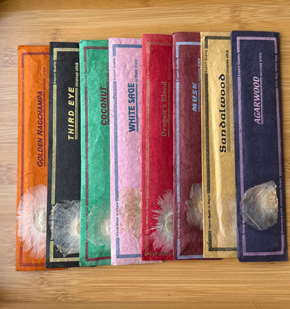 Set of eight handmade incense stick packs from Nepal in assorted natural scents, including Golden Nag Champa, Third Eye, Coconut, White Sage, Dragon’s Blood, Musk, Sandalwood, and Agarwood, wrapped in colorful eco-friendly lokta paper, part of the Sacred Scents & Space collection by Suzy’s Treasures.