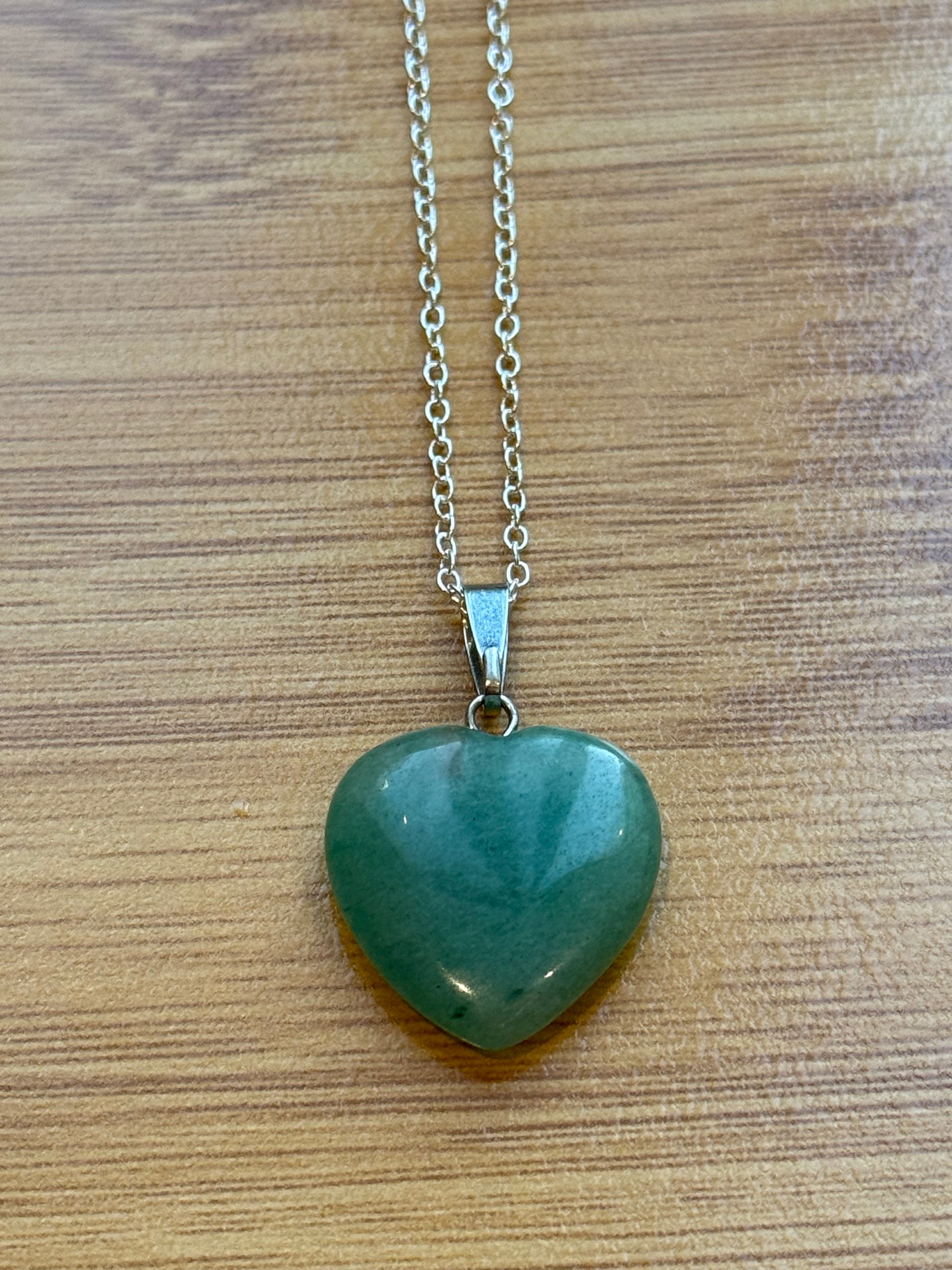 Green Aventurine pendant in heart shape with sterling silver chain on wooden background – Suzys Treasures