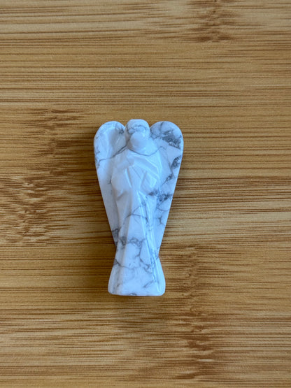 Howlite angel crystal carving on a wooden background – Suzy's Treasures