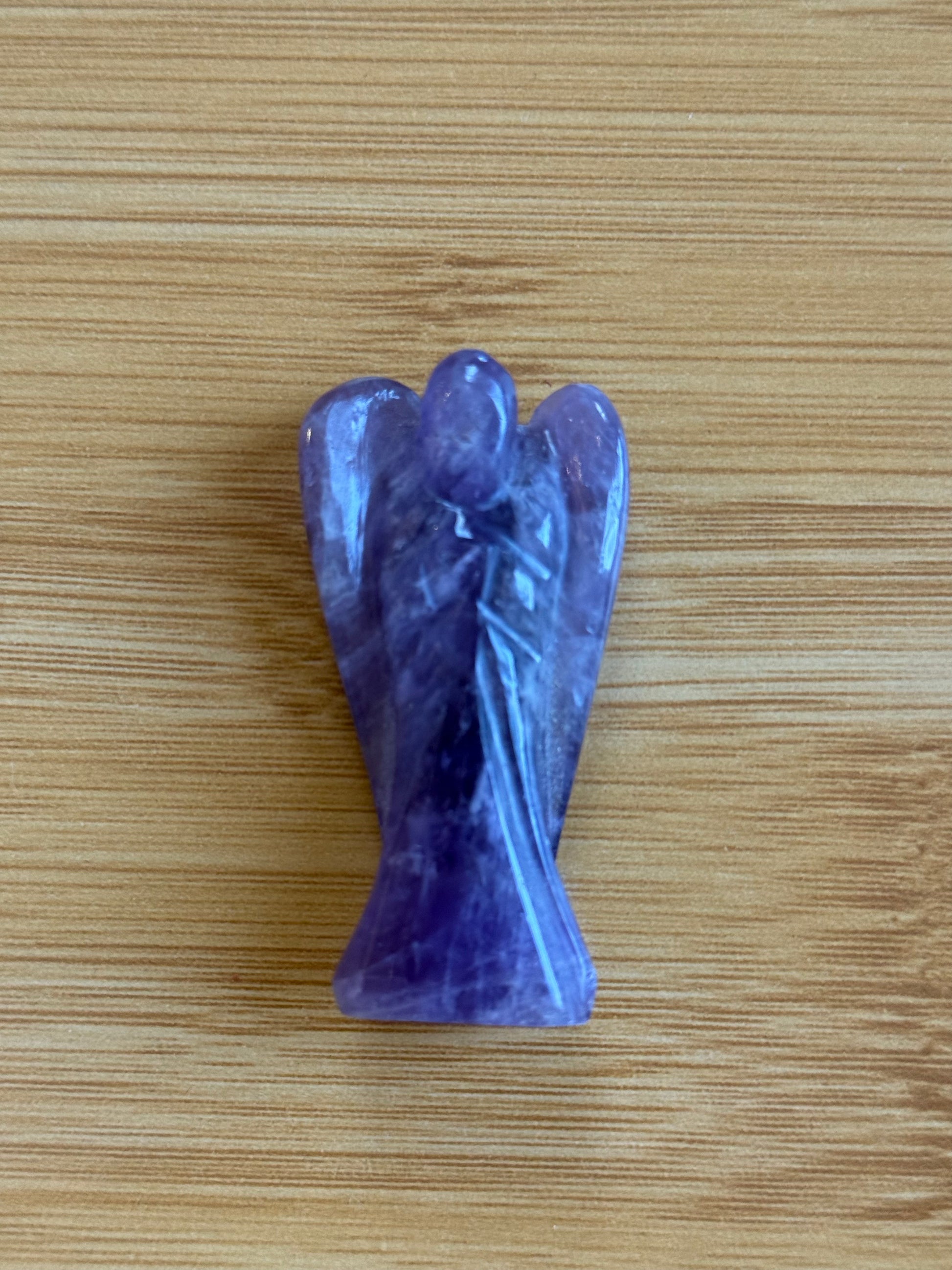 Amethyst angel crystal carving on a wooden background – Suzy's Treasures