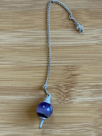 Amethyst round crystal pendulum with silver chain on wooden background – Suzys Treasures