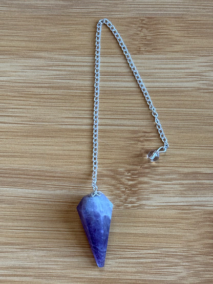 Amethyst long crystal pendulum with silver chain on wooden background – Suzys Treasures
