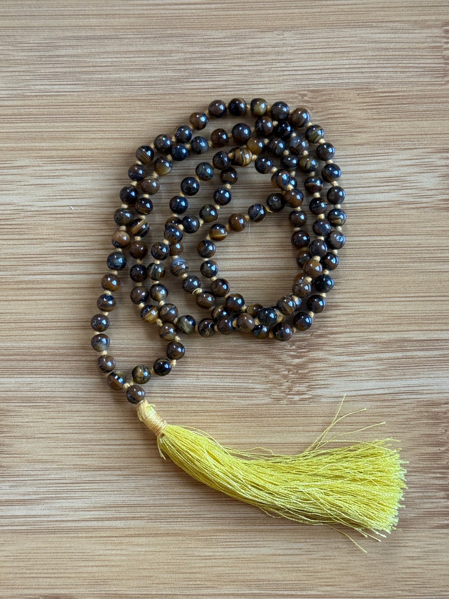 108-bead Tiger Eye mala necklace with rich golden-brown 6mm beads and yellow tassel, for courage and confidence – from Suzys Treasures.