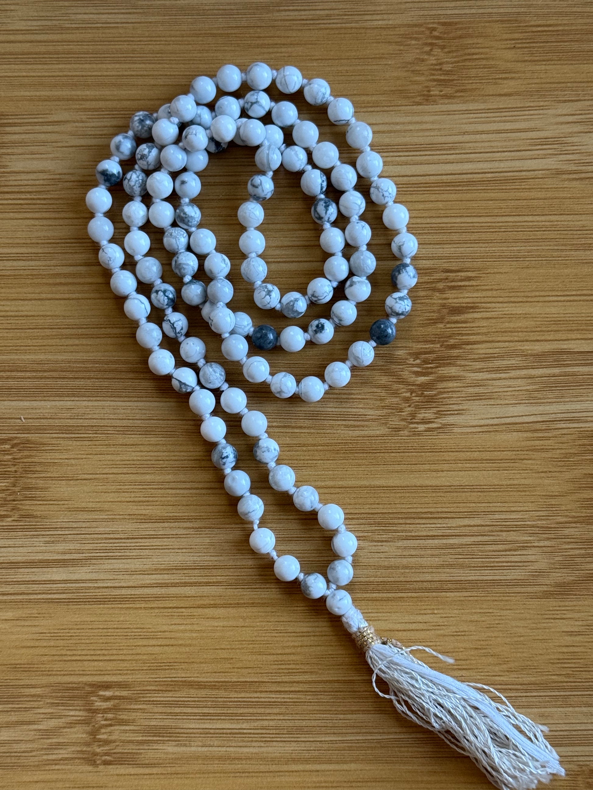 108-bead Howlite mala necklace with 6mm white marbled beads and white tassel, used for calming and clarity – from Suzys Treasures.