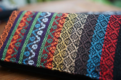 A close-up of the vibrant Multi wallet from Suzys Treasures, showcasing the stunning details of its intricate handwoven fabric in rainbow colors. Crafted with love and tradition in every stitch.
