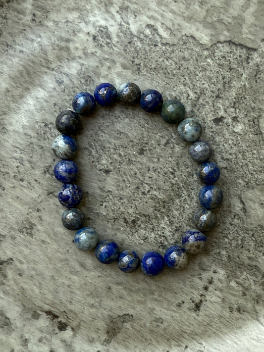 Lapis Lazuli round bead bracelet featuring 21–22 deep blue polished stones, known for enhancing wisdom and inner truth – from Suzys Treasures.