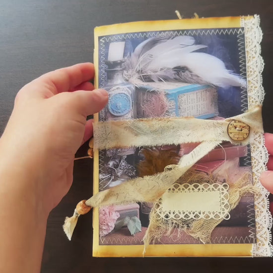 Handmade vintage-inspired journal featuring feathers, apothecary bottles, and lace detailing – a whimsical creation from Suzys Treasures.